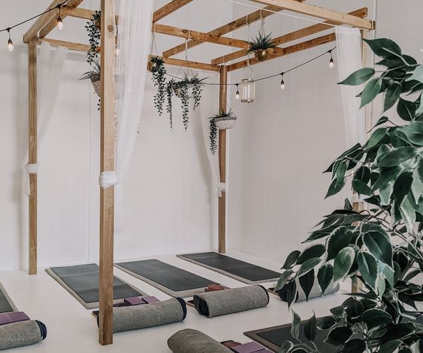 Soft morning light shining on a comfortable yoga mat space